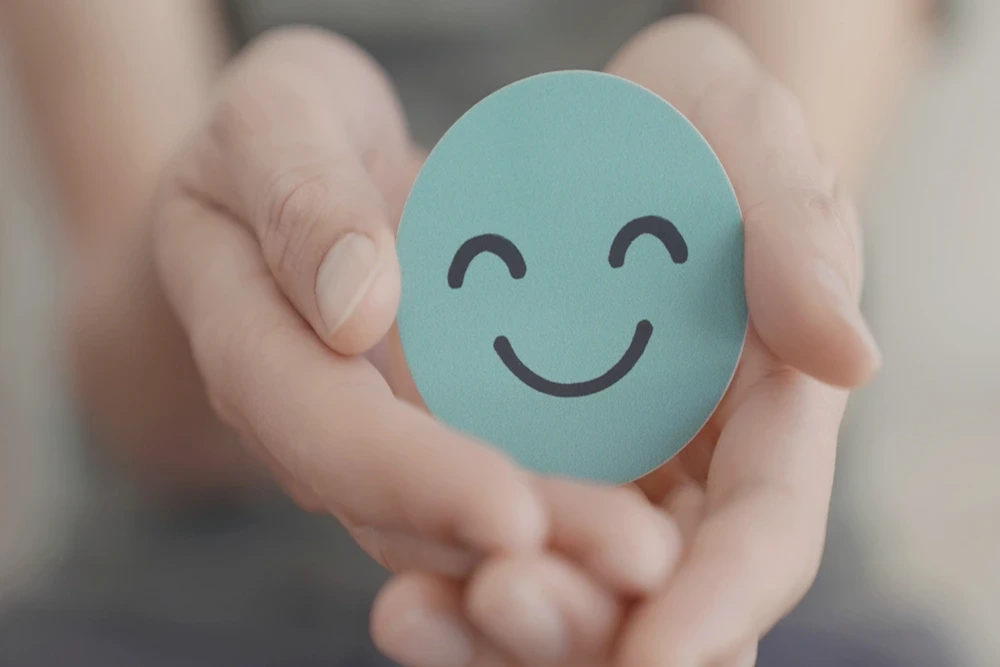 Psychologist (4) YBL AH Psychologist is holding a smiley face card